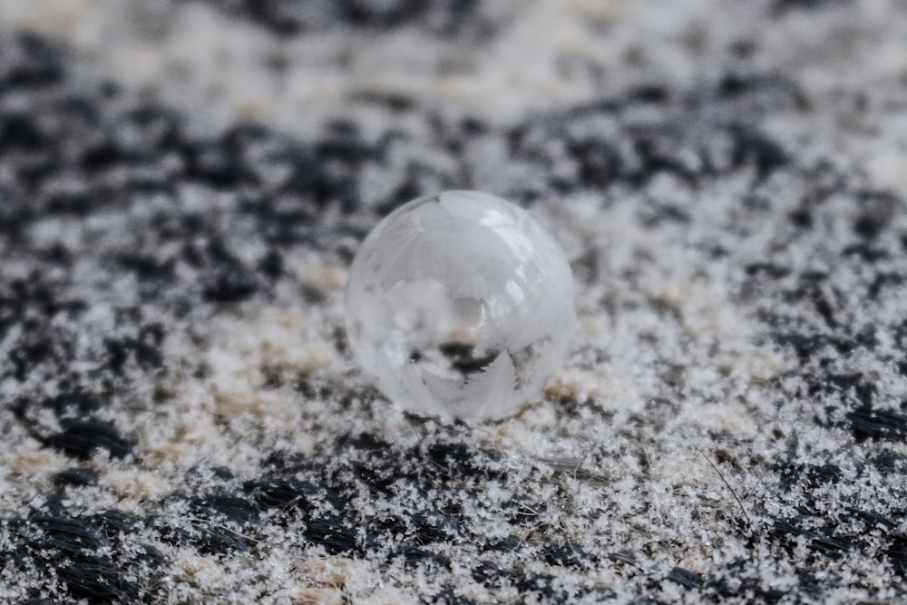 a snow globe sitting on top of a pile of snow