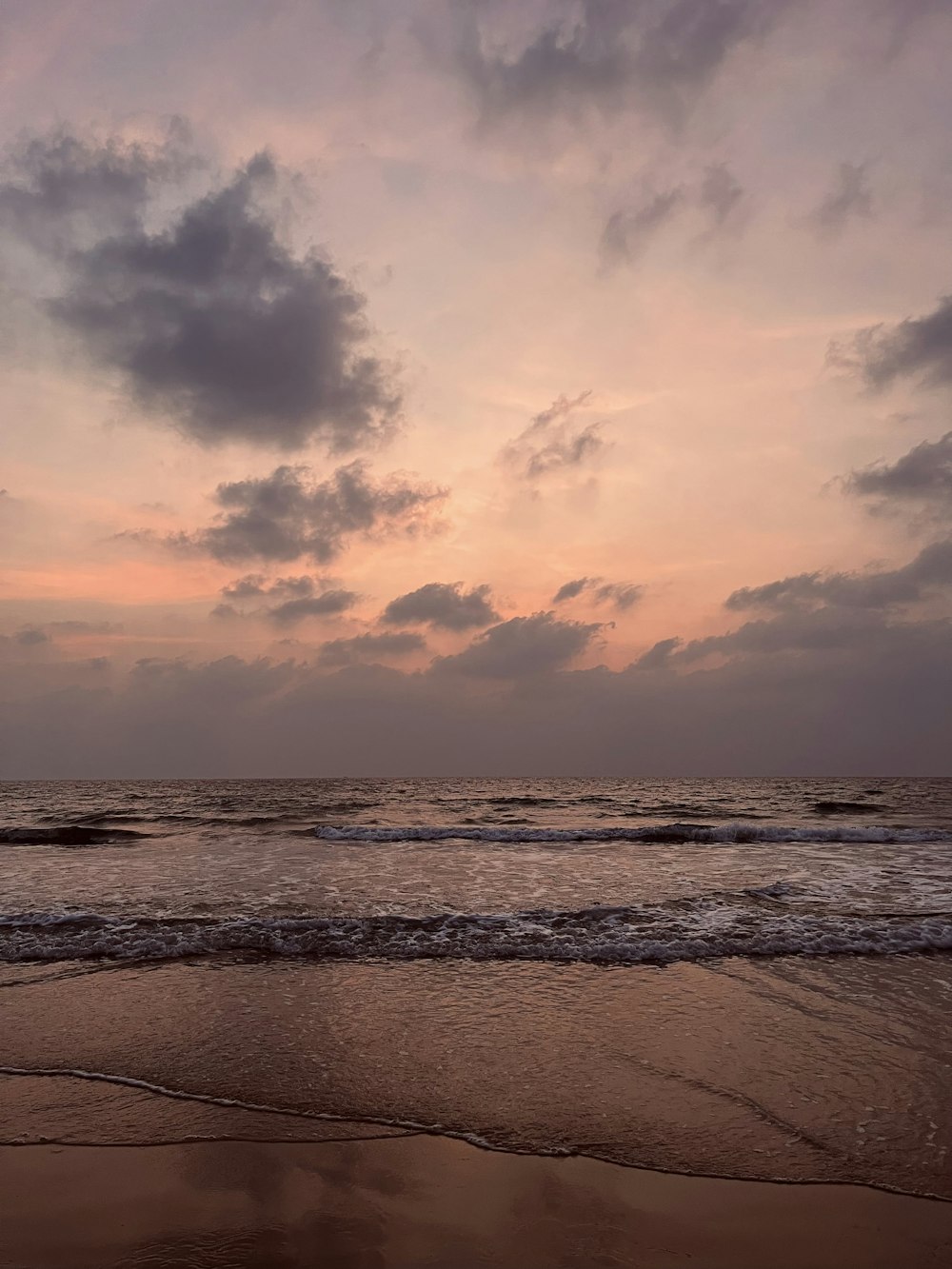 a beach with waves coming in to shore