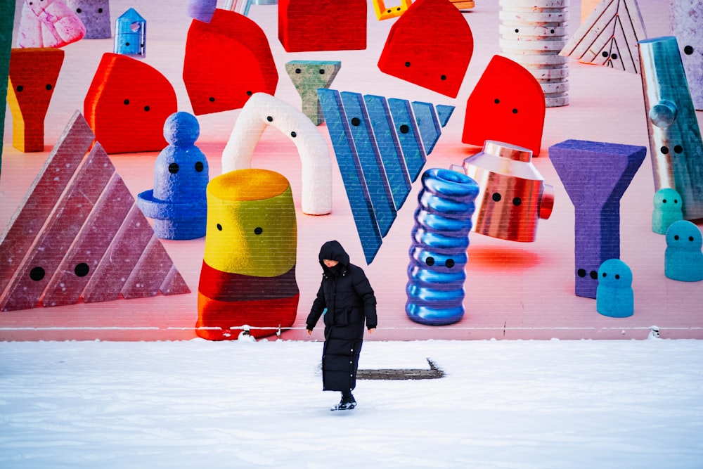 a person on a snowboard in front of a colorful wall