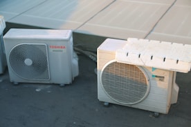 a couple of air conditioners sitting next to each other