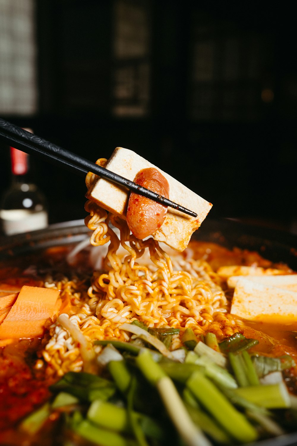 a bowl of ramen with chopsticks sticking out of it