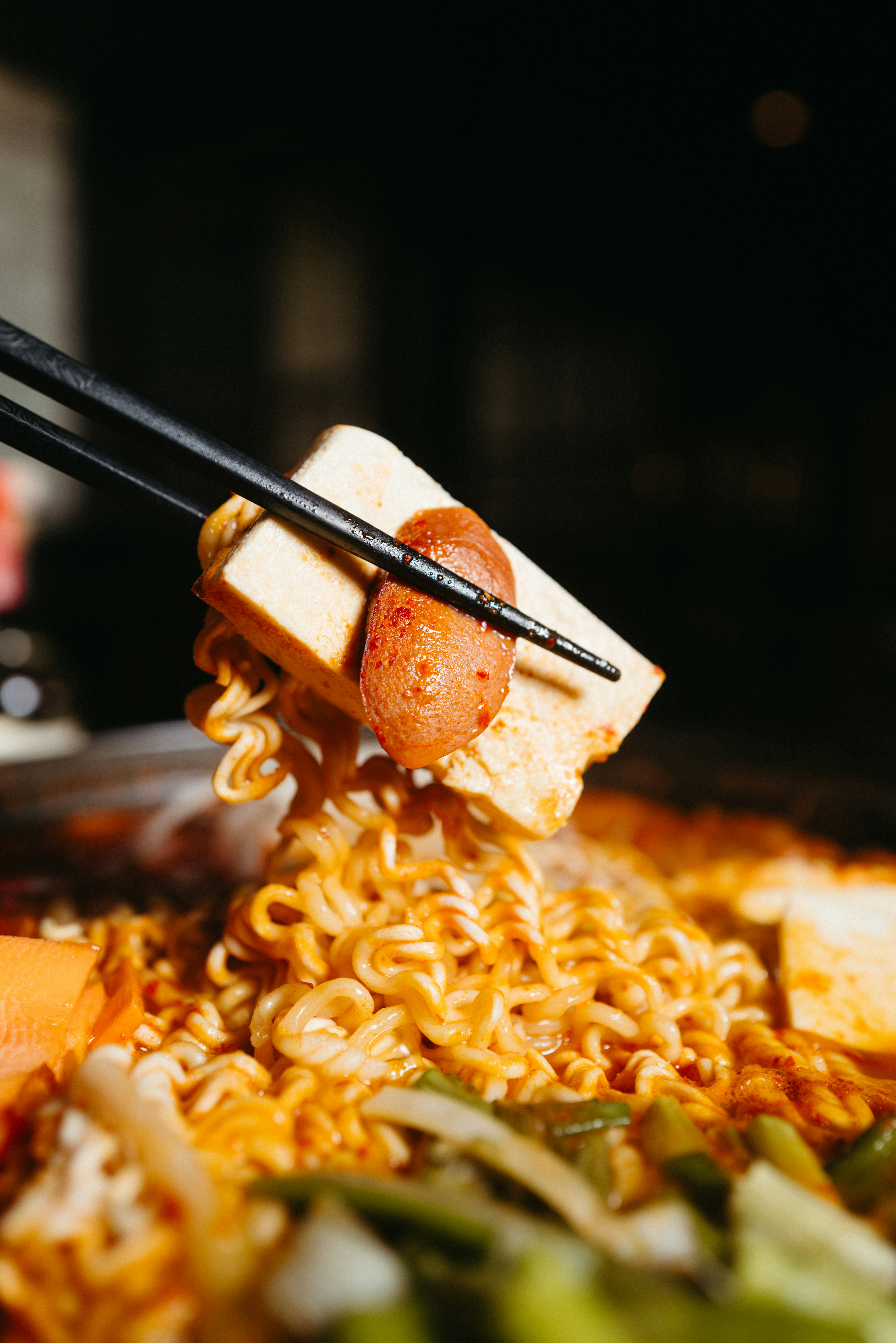 chopsticks sticking out of a bowl of noodles