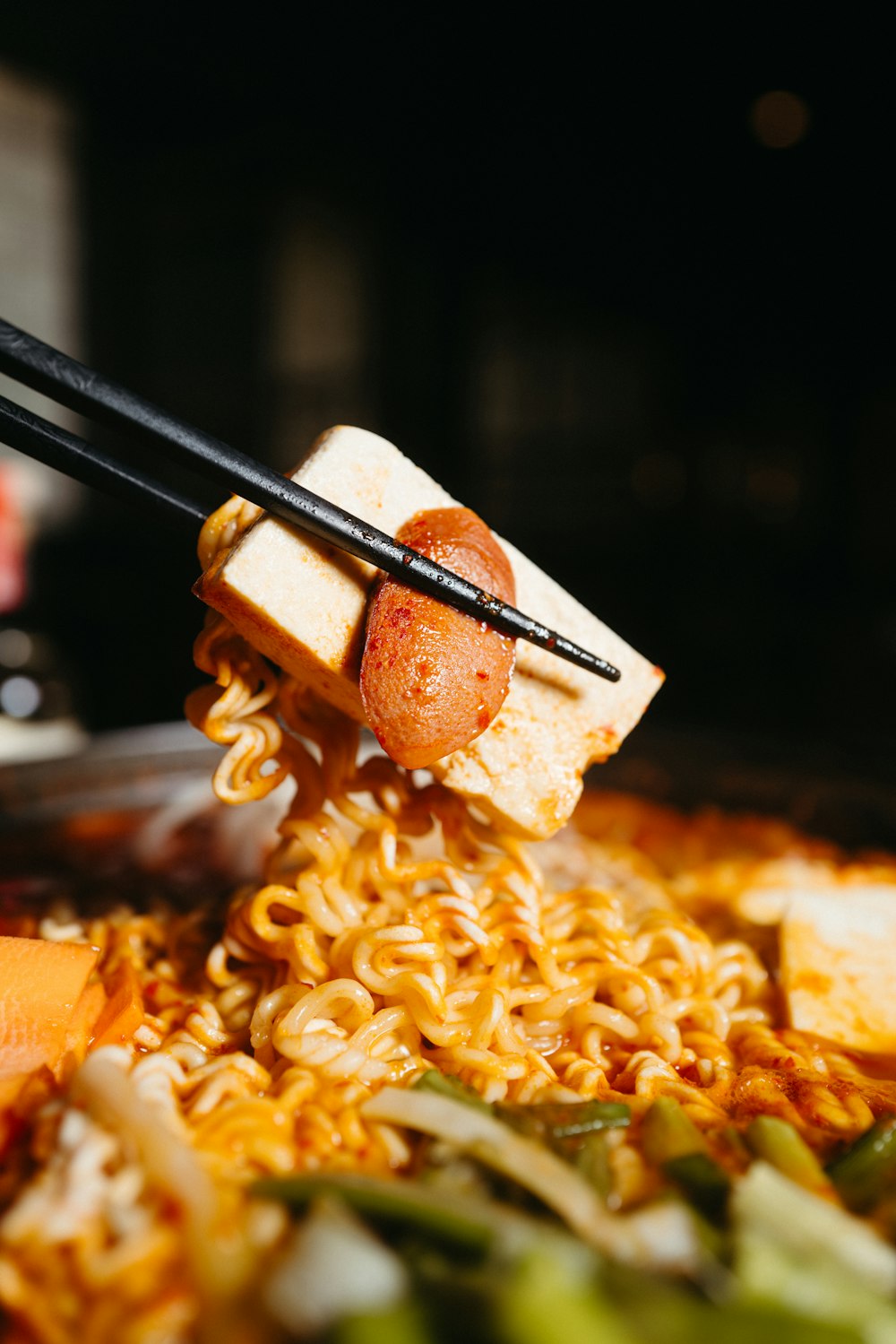 chopsticks sticking out of a bowl of noodles
