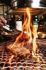 a person is grilling some food on a grill