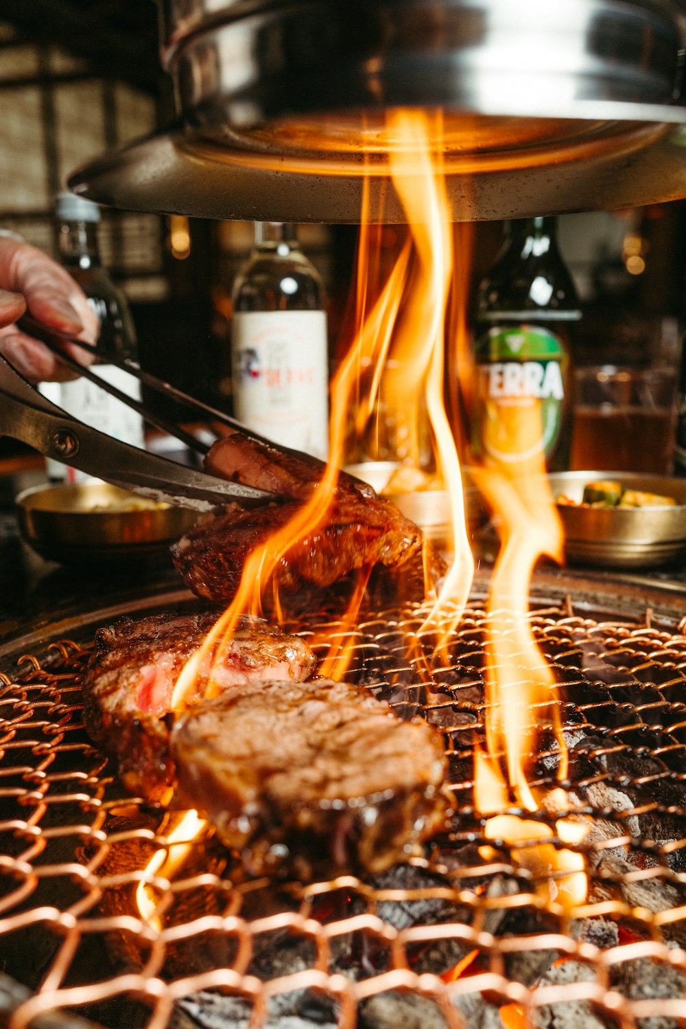 a person is grilling some food on a grill