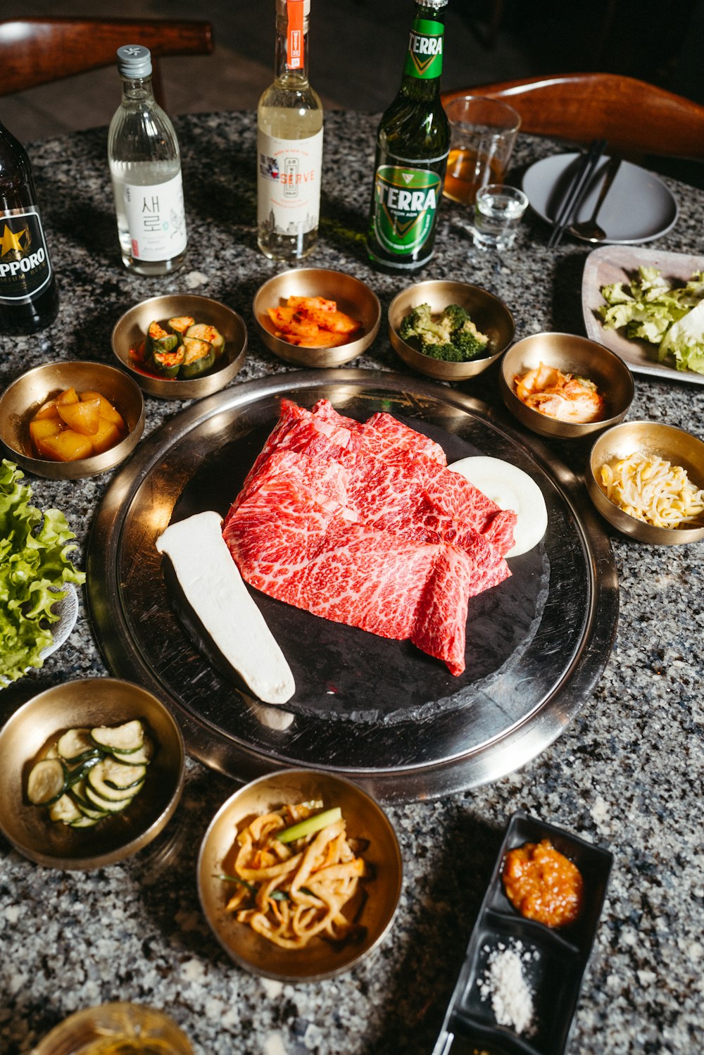 a table topped with bowls and plates of food