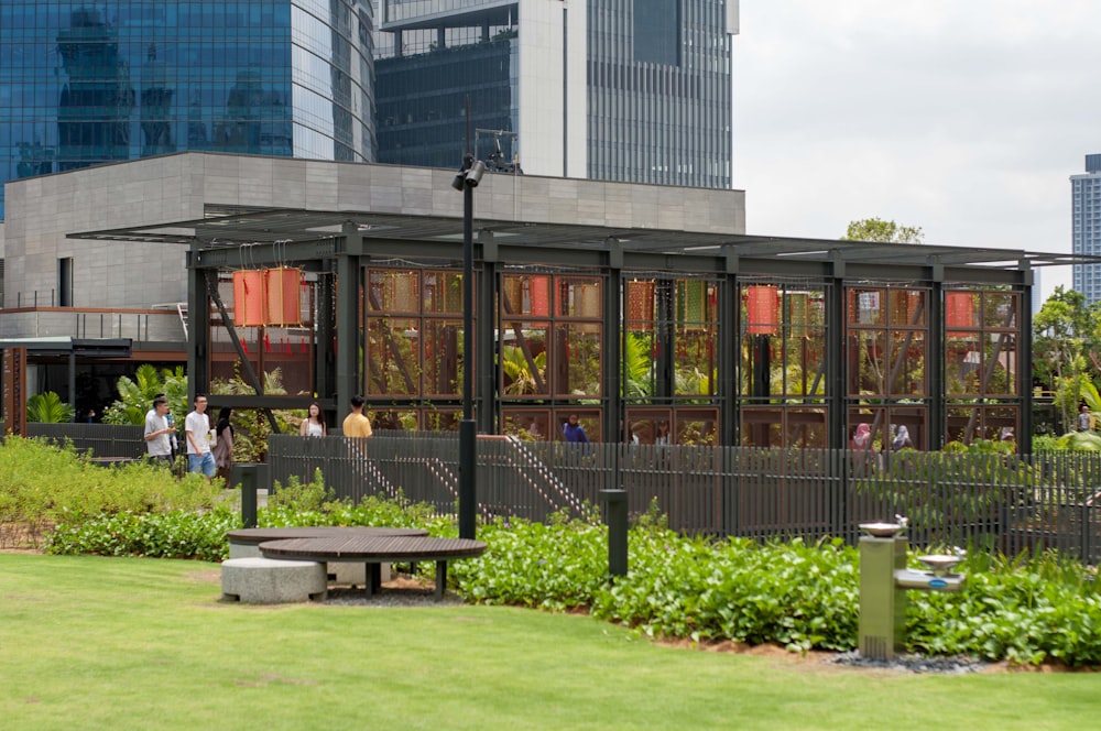 a group of people walking around a lush green park