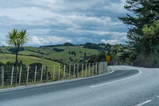 a road with a fence on the side of it