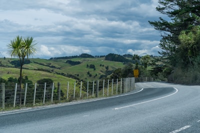 a road with a fence on the side of it
