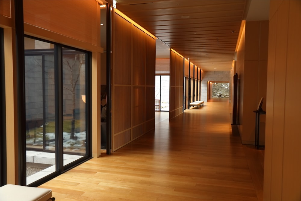 a long hallway with wooden floors and sliding glass doors