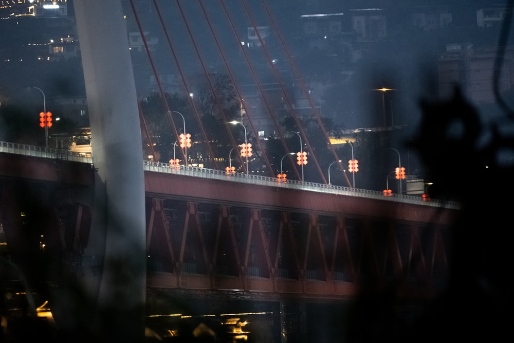 a view of a bridge at night through a window