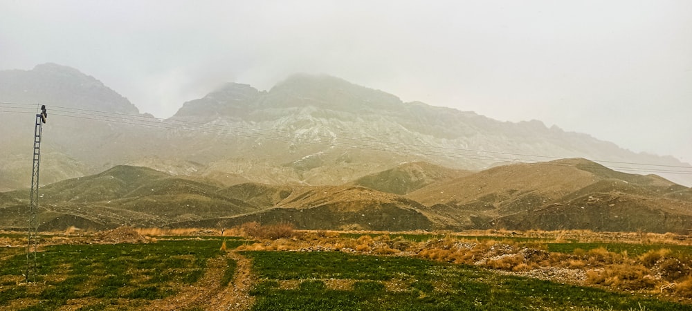 a mountain range with a telephone pole in the foreground