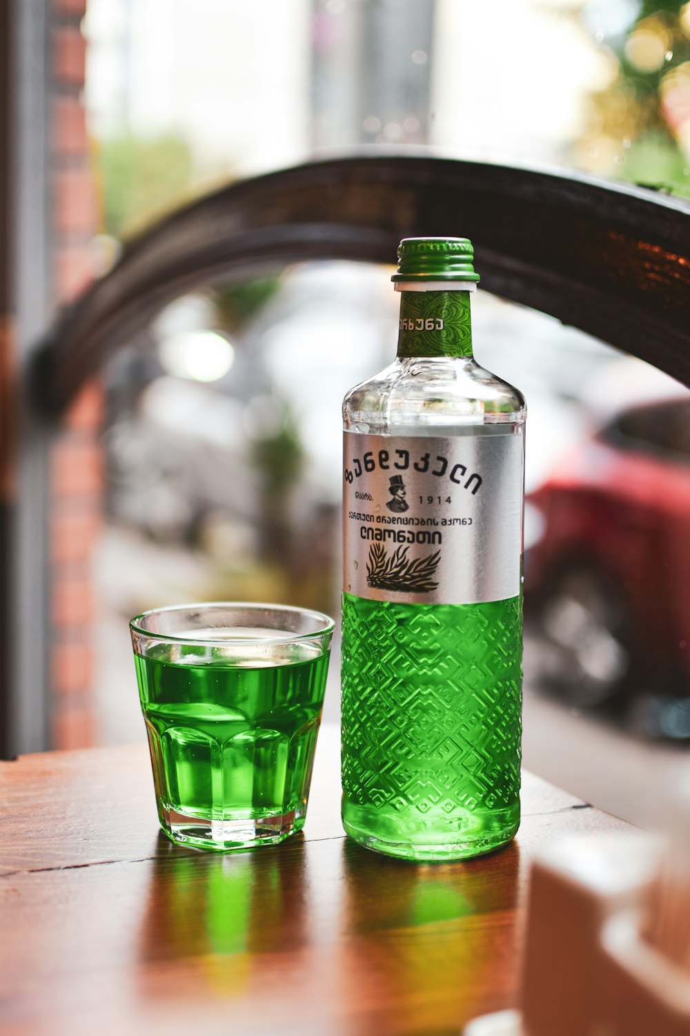 a bottle of alcohol sitting next to a shot glass