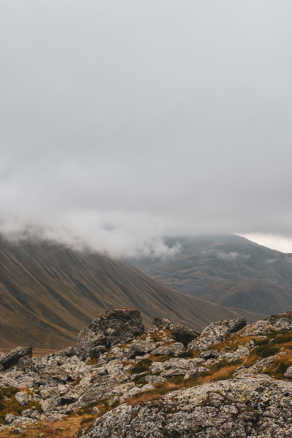 a man standing on top of a rocky hillside