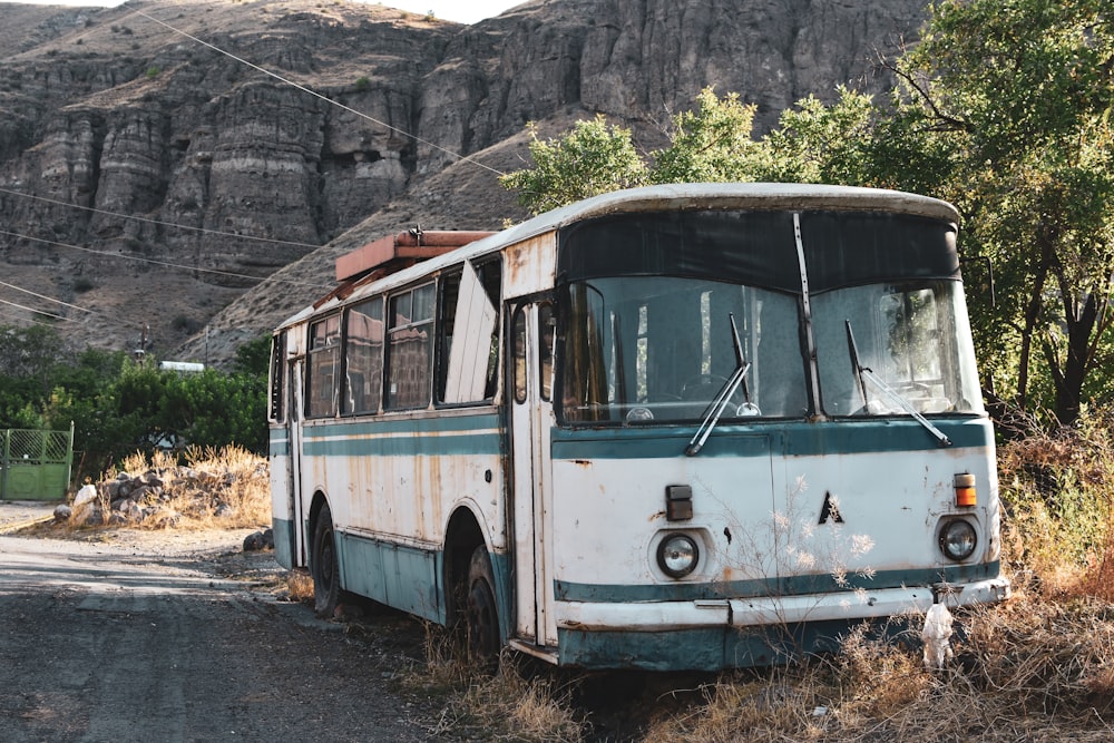 an old bus sitting on the side of a road