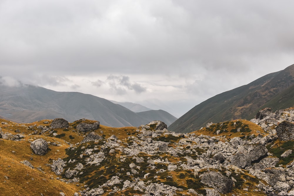 a mountain range covered in grass and rocks