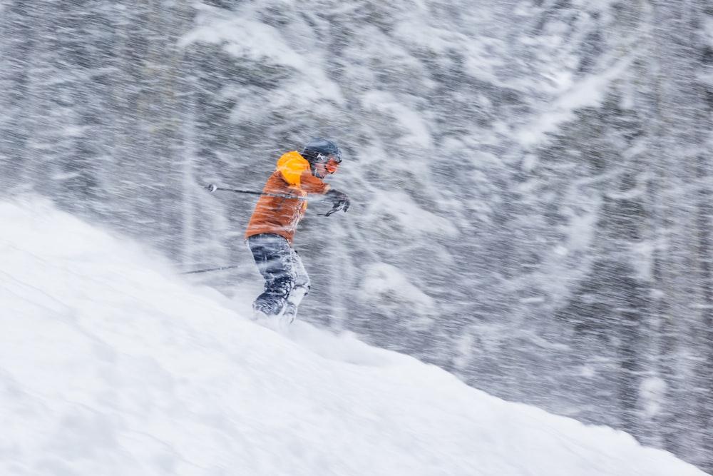 a man riding skis down a snow covered slope