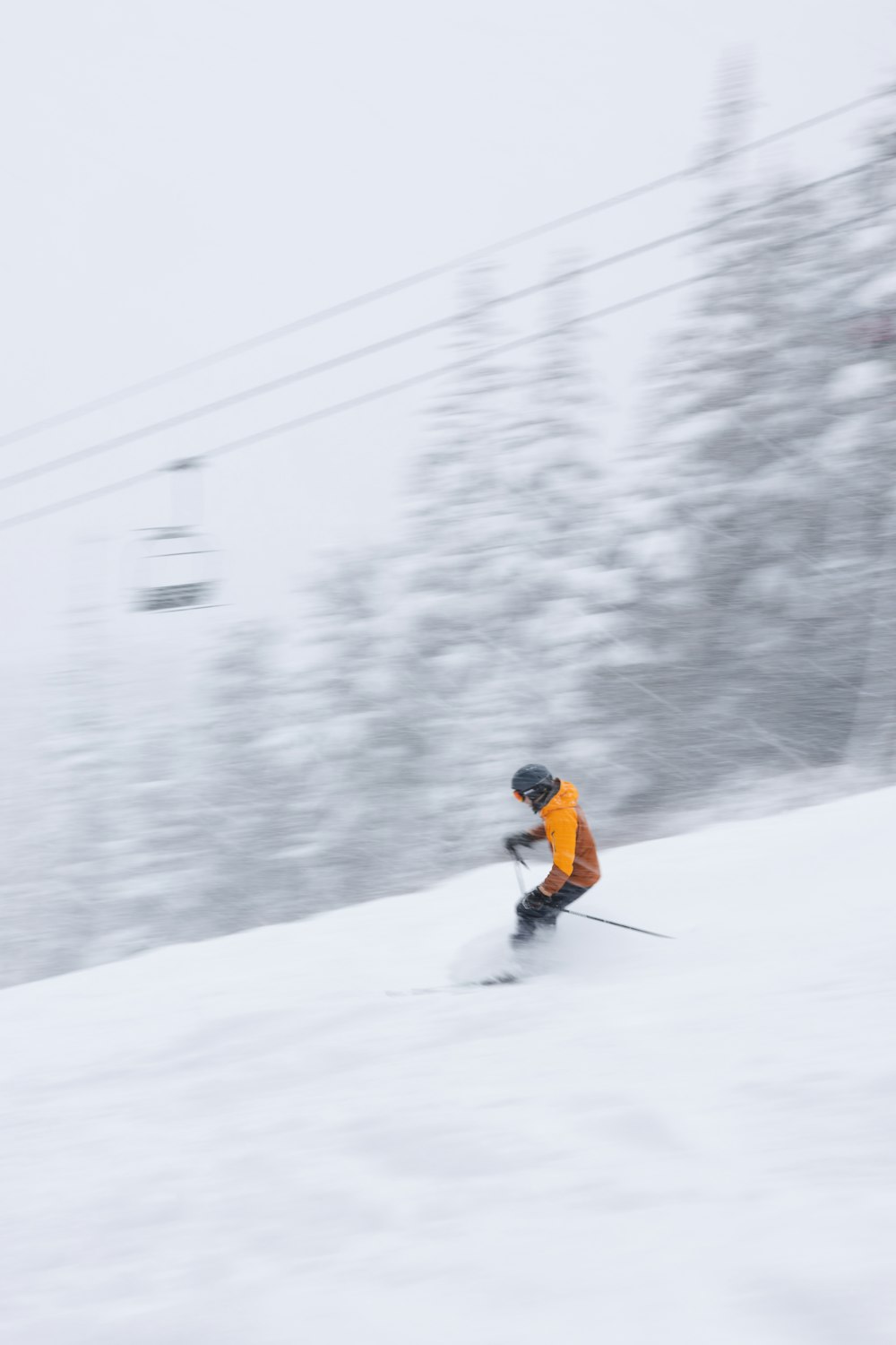 a man riding skis down a snow covered slope