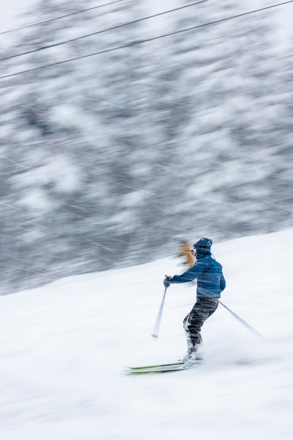 a person riding skis down a snow covered slope