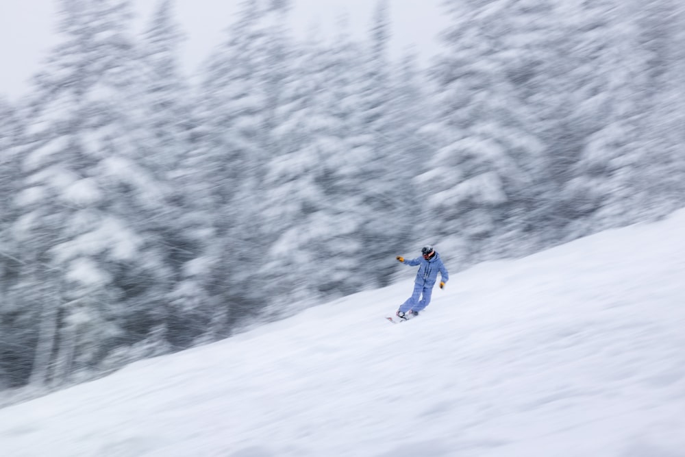 a person riding skis down a snow covered slope