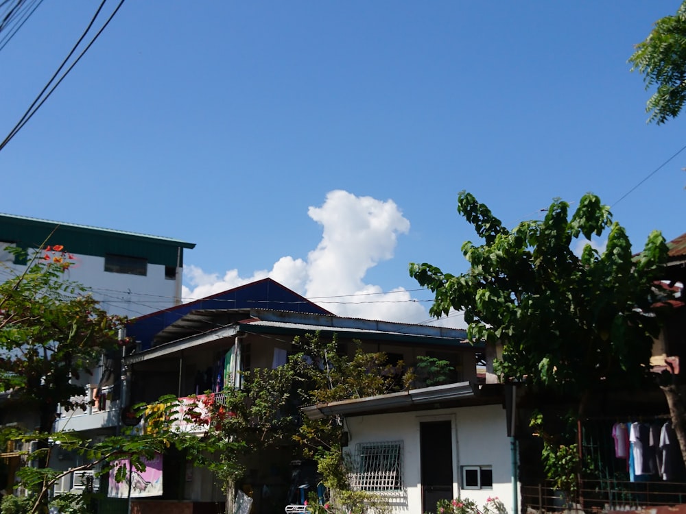 a white house with a blue sky and clouds in the background