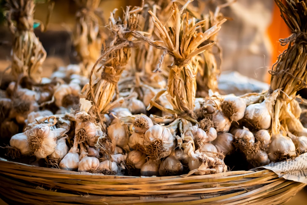 a basket filled with lots of garlic on top of a table