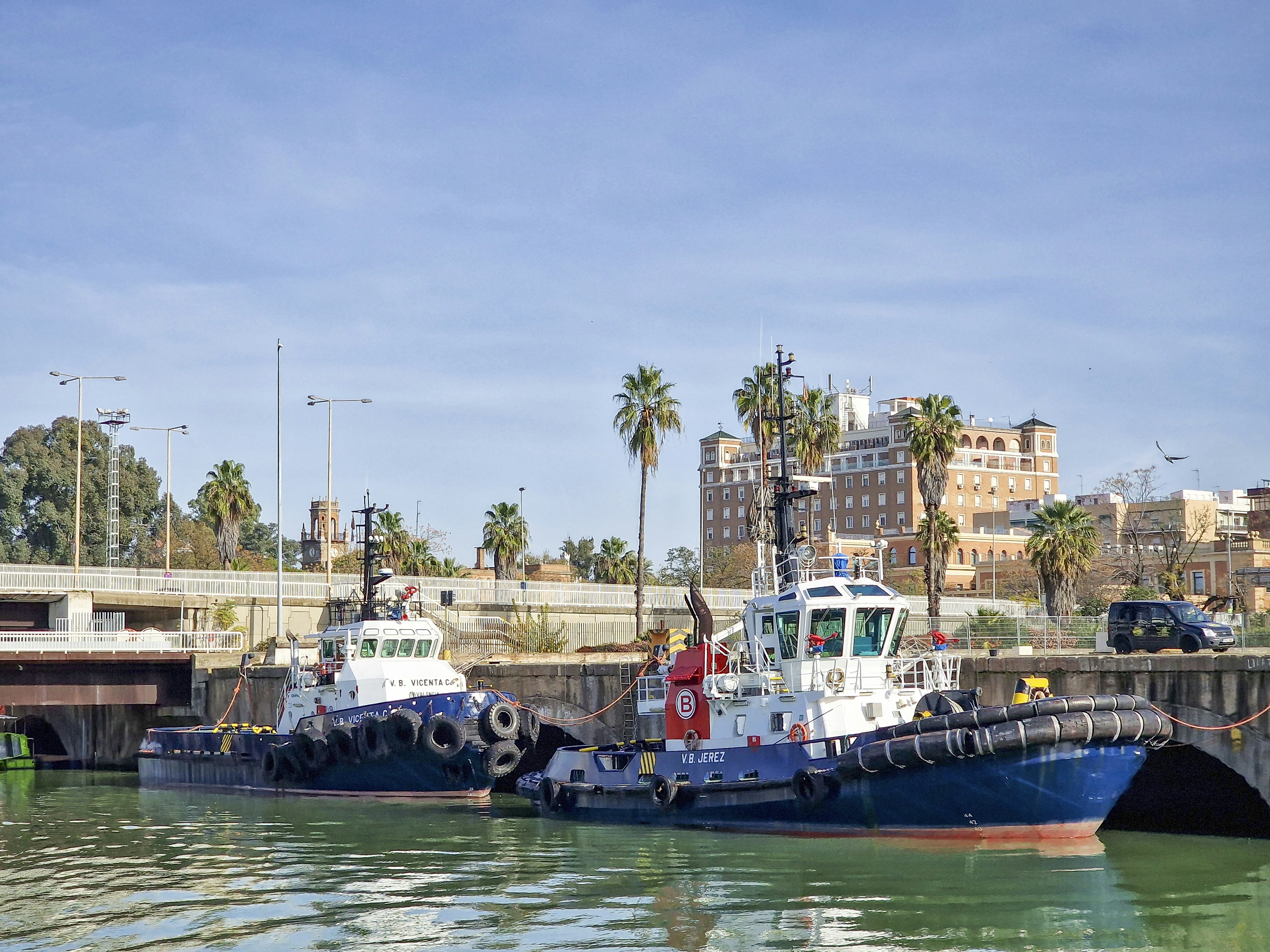 two tug boats are docked in the water