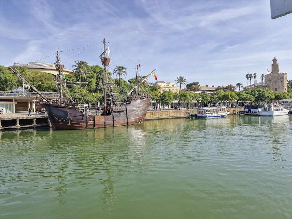 a boat docked at a dock in a harbor