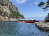 a red and white boat in a body of water