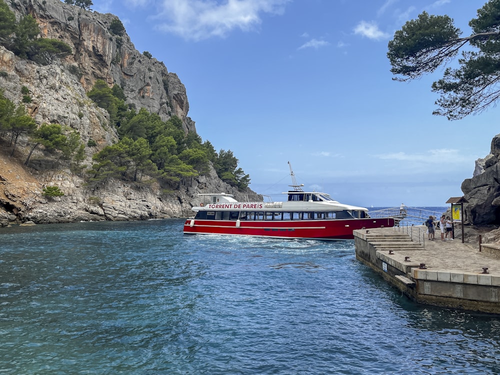 a red and white boat in a body of water