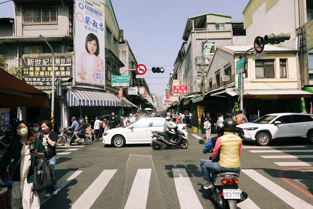 a busy city street filled with people and cars