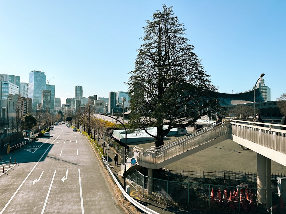 a view of a city street with a bridge in the foreground