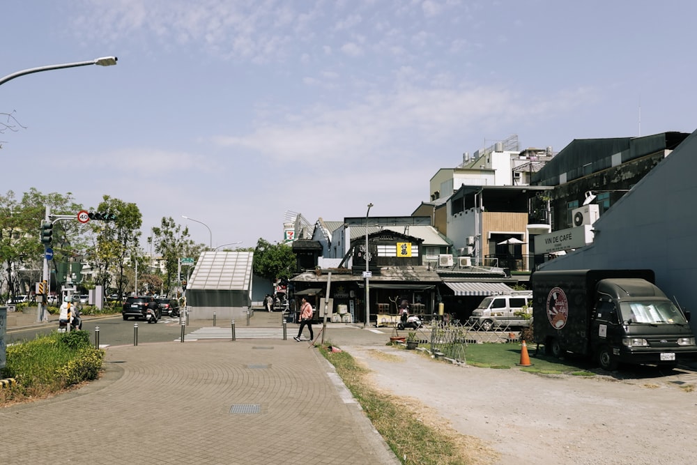 a street scene with a car parked on the side of the road