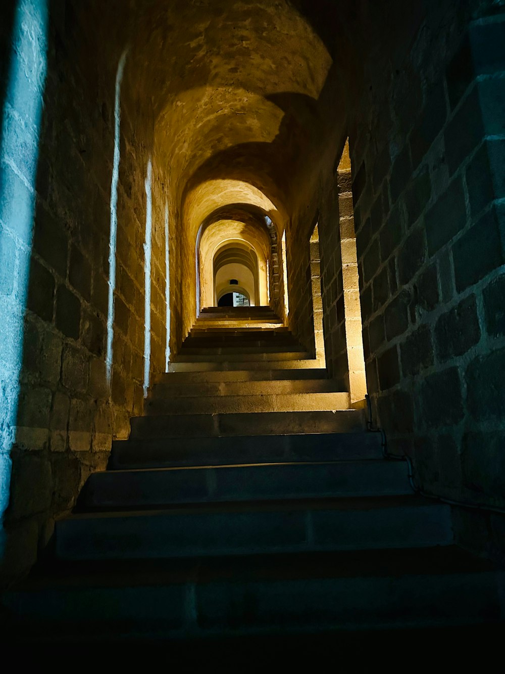 a dark tunnel with stairs leading up to it