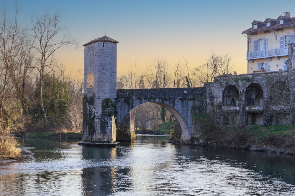 a bridge over a river next to a tall building