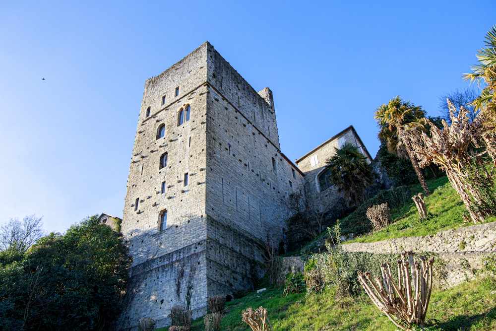 an old stone building on a steep hill