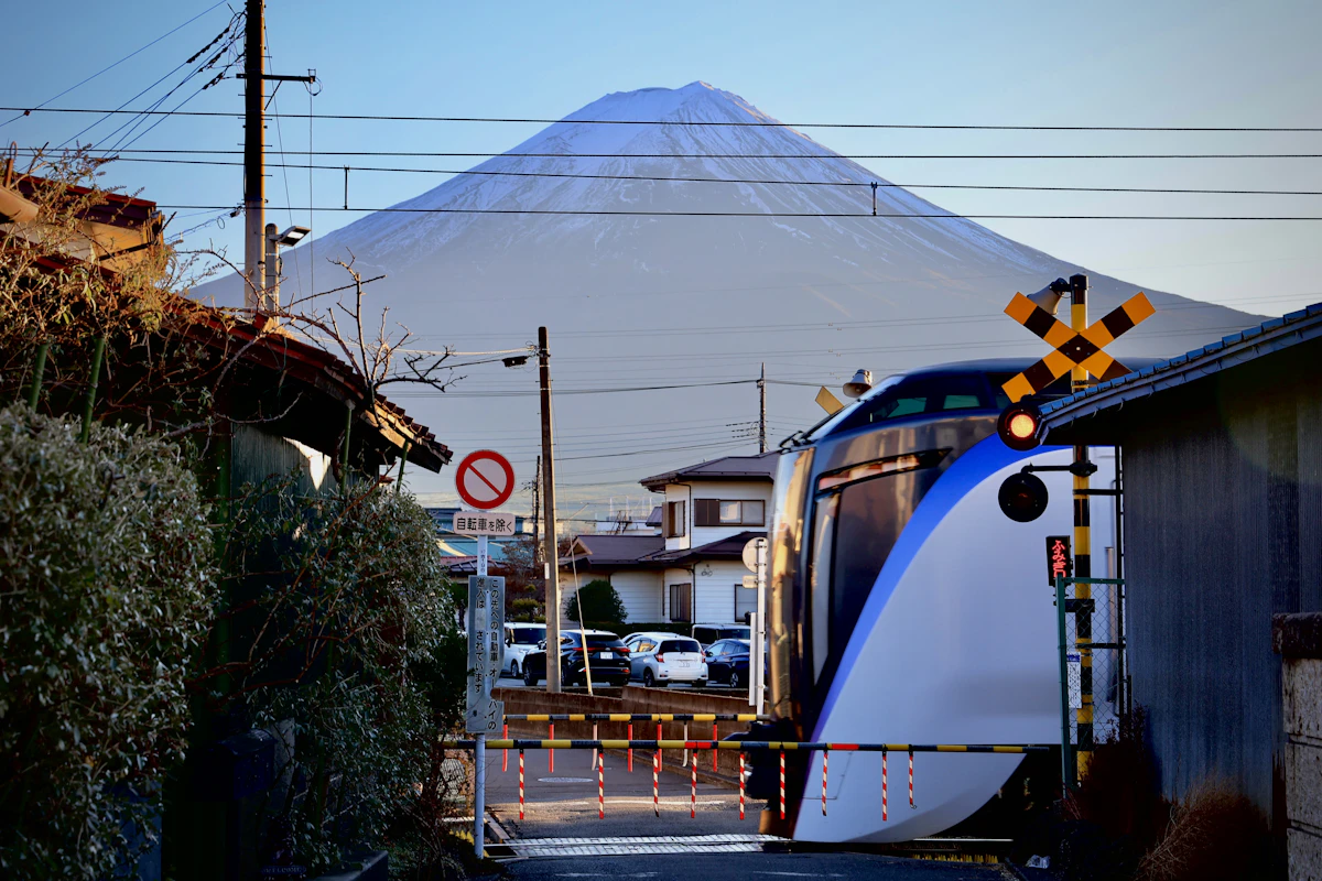 A Shinkansen bullet train passing a mountain in Japan