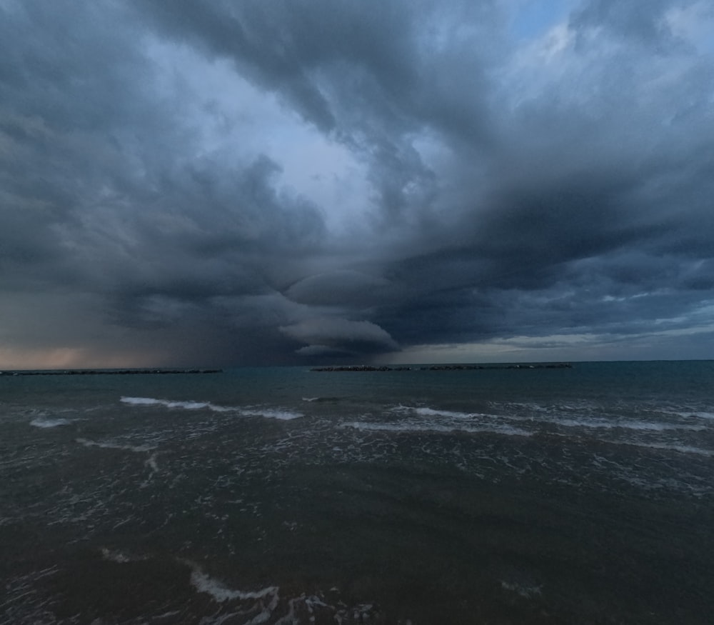 a storm moving across the sky over a body of water