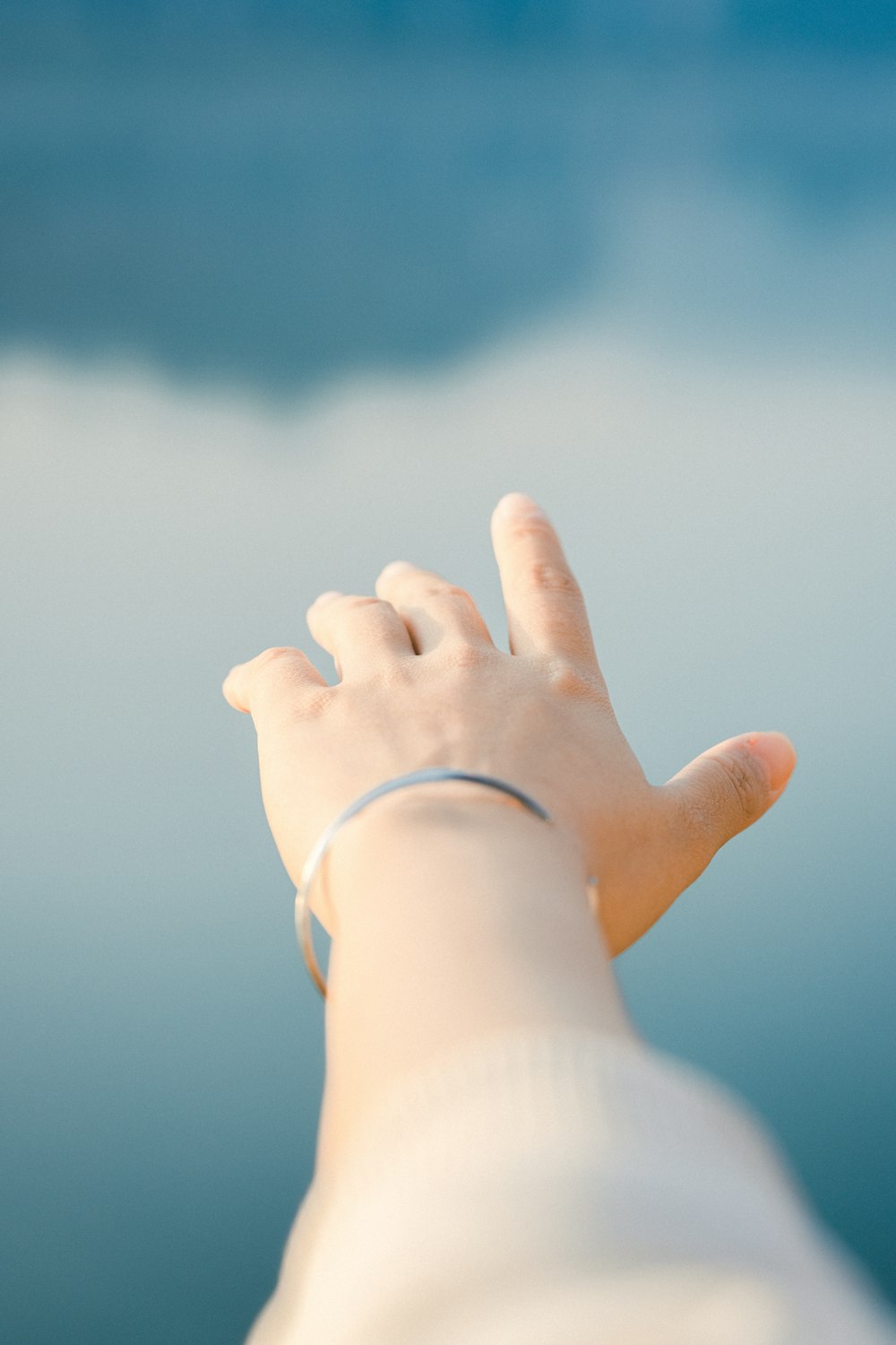 a person holding their hand up to the sky