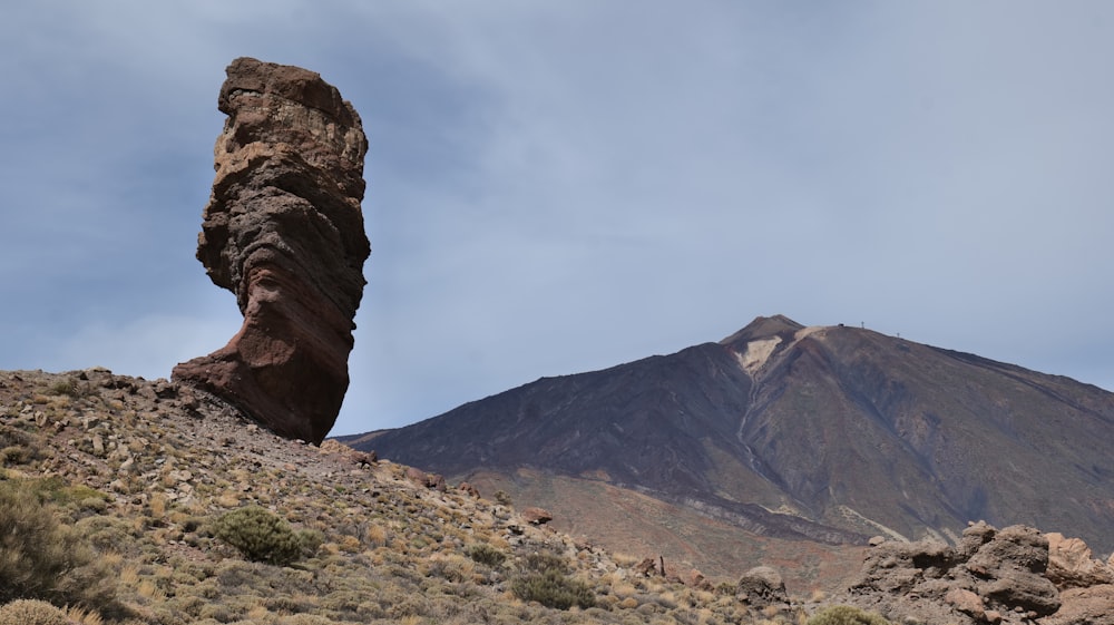 a large rock sticking out of the side of a mountain