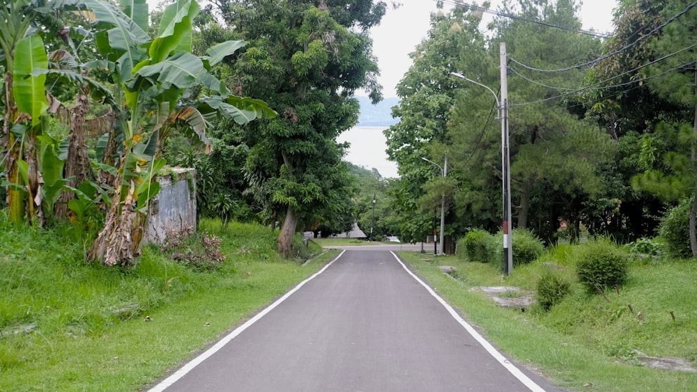 an empty road with a stop sign on the side of it