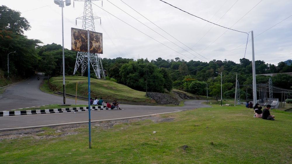 a group of people sitting on the side of a road