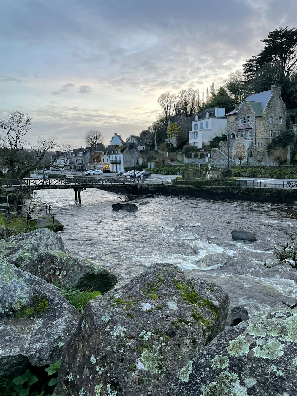 a body of water surrounded by rocks and houses