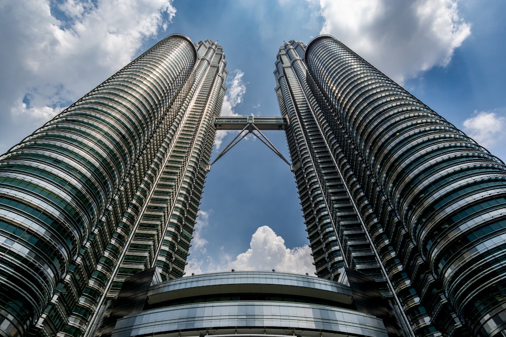 two very tall buildings towering into the sky