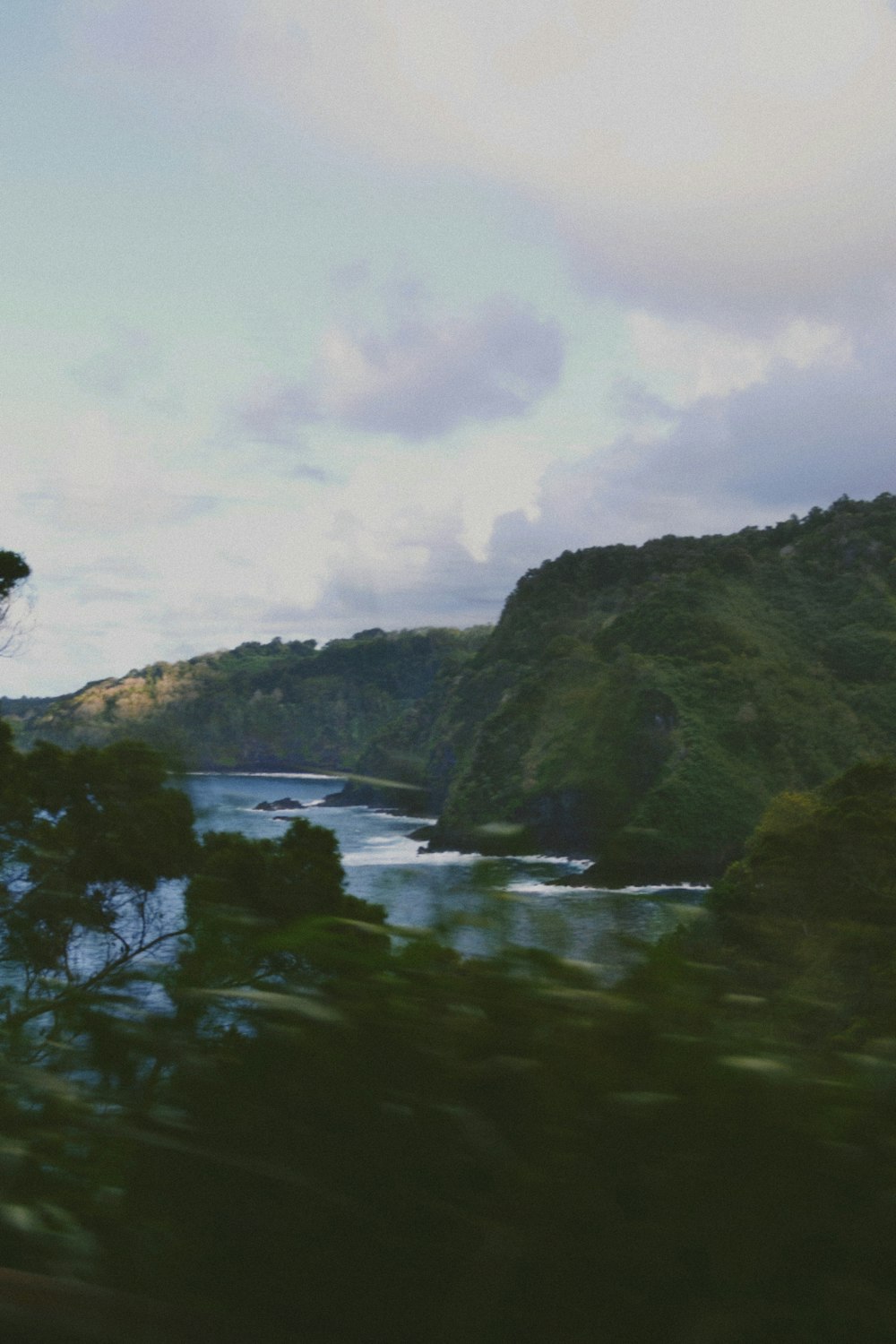 a view of a body of water from a moving train