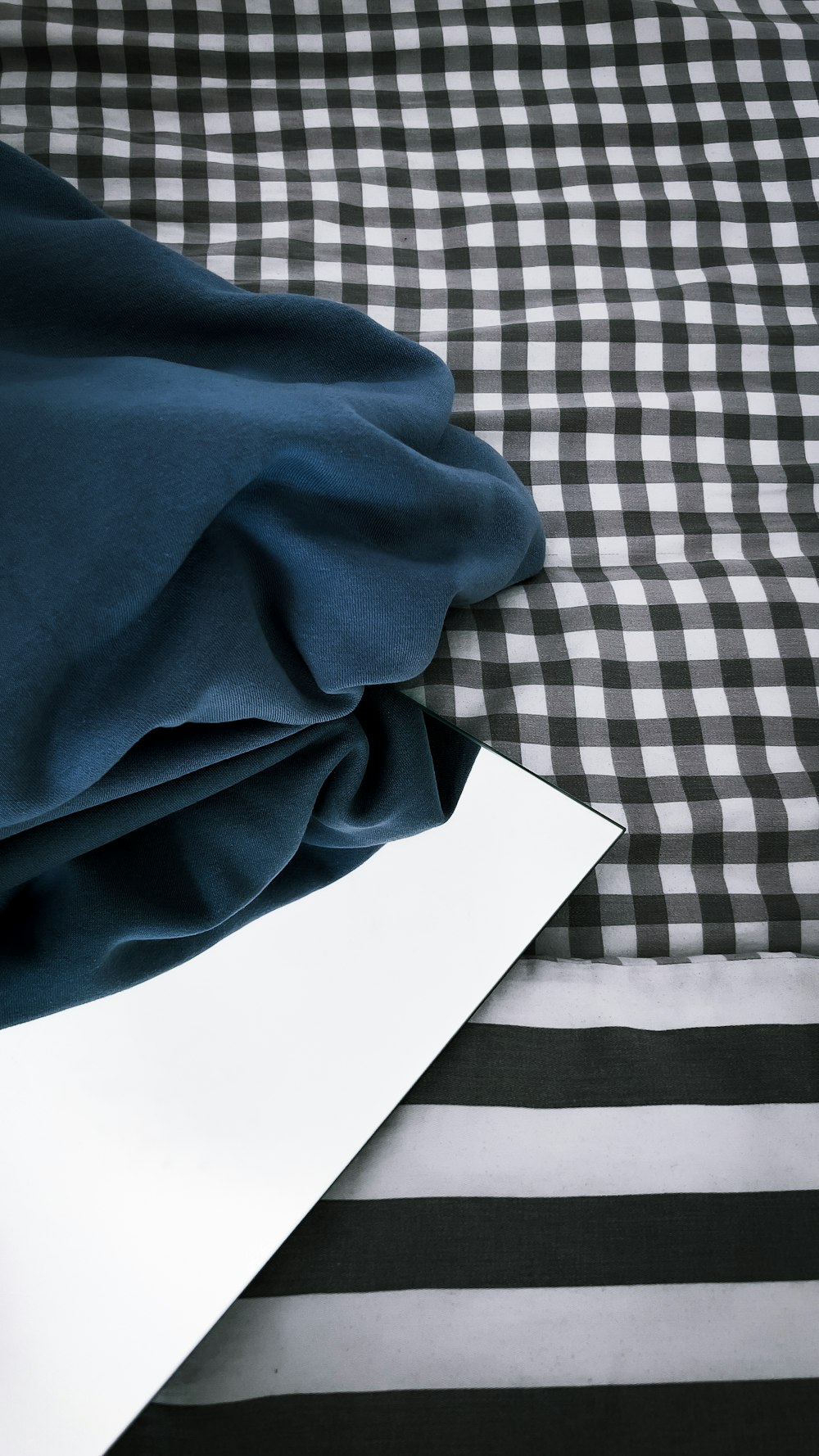 a black and white checkered bed spread with a white sheet