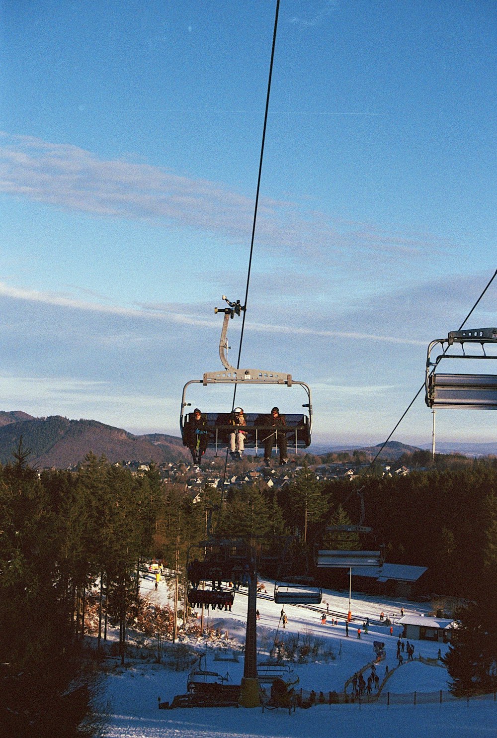 a couple of people riding a ski lift