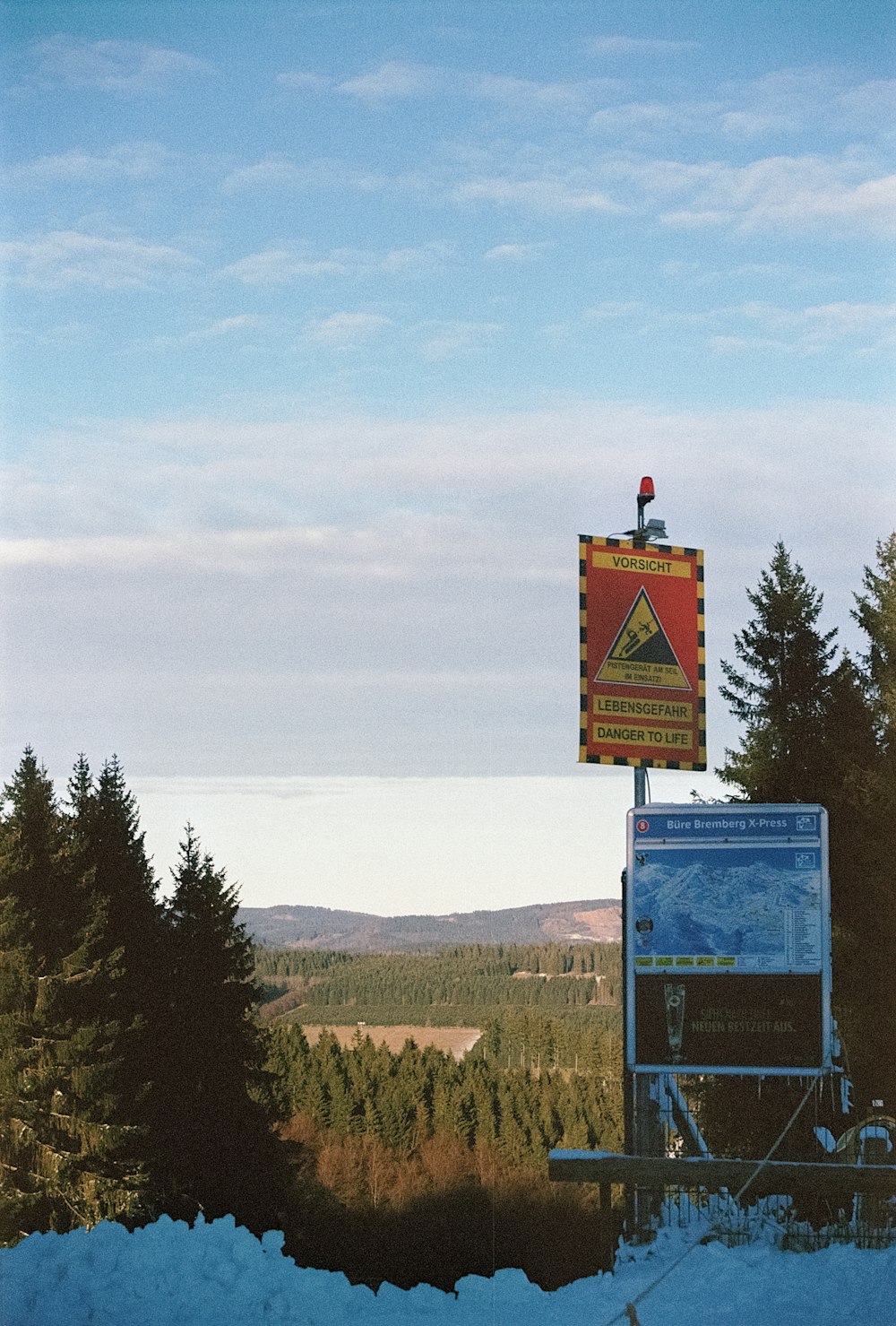 a sign on top of a truck in the snow