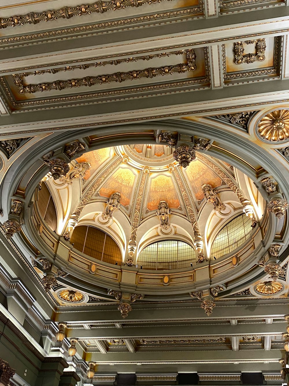 a ceiling in a building with a clock on it