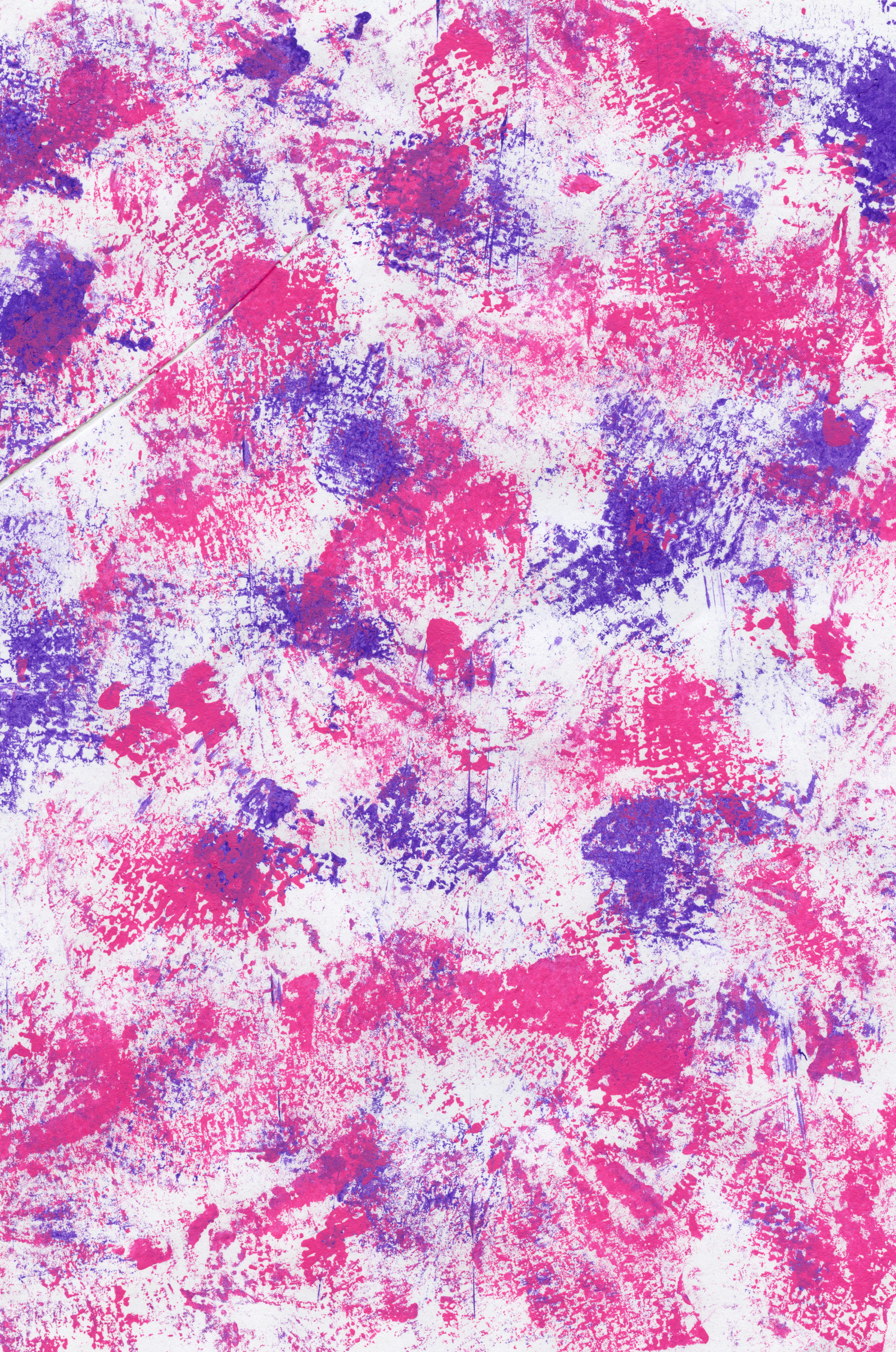 a pink and purple paint splattered on a white surface